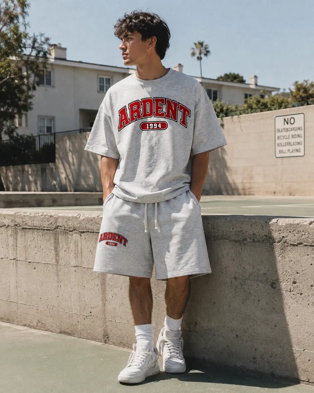 Student wearing the grey Ardent tee and shorts set with red ARDENT varsity lettering