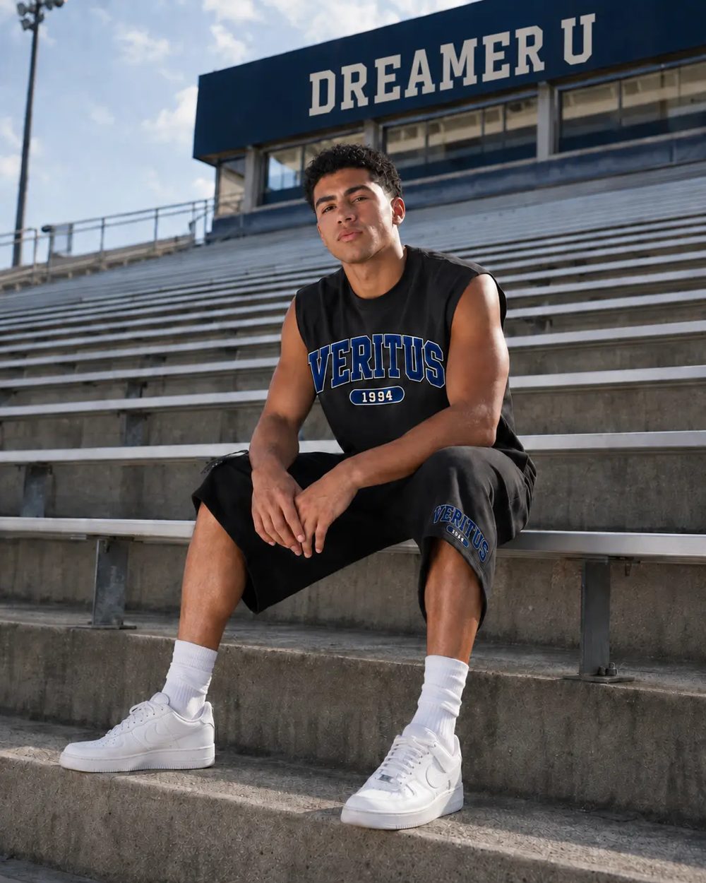 Student wearing the black Veritus sleeveless tee and shorts with navy VERITUS lettering